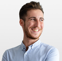 Smiling with teeth brown-haired guy in blue shirt